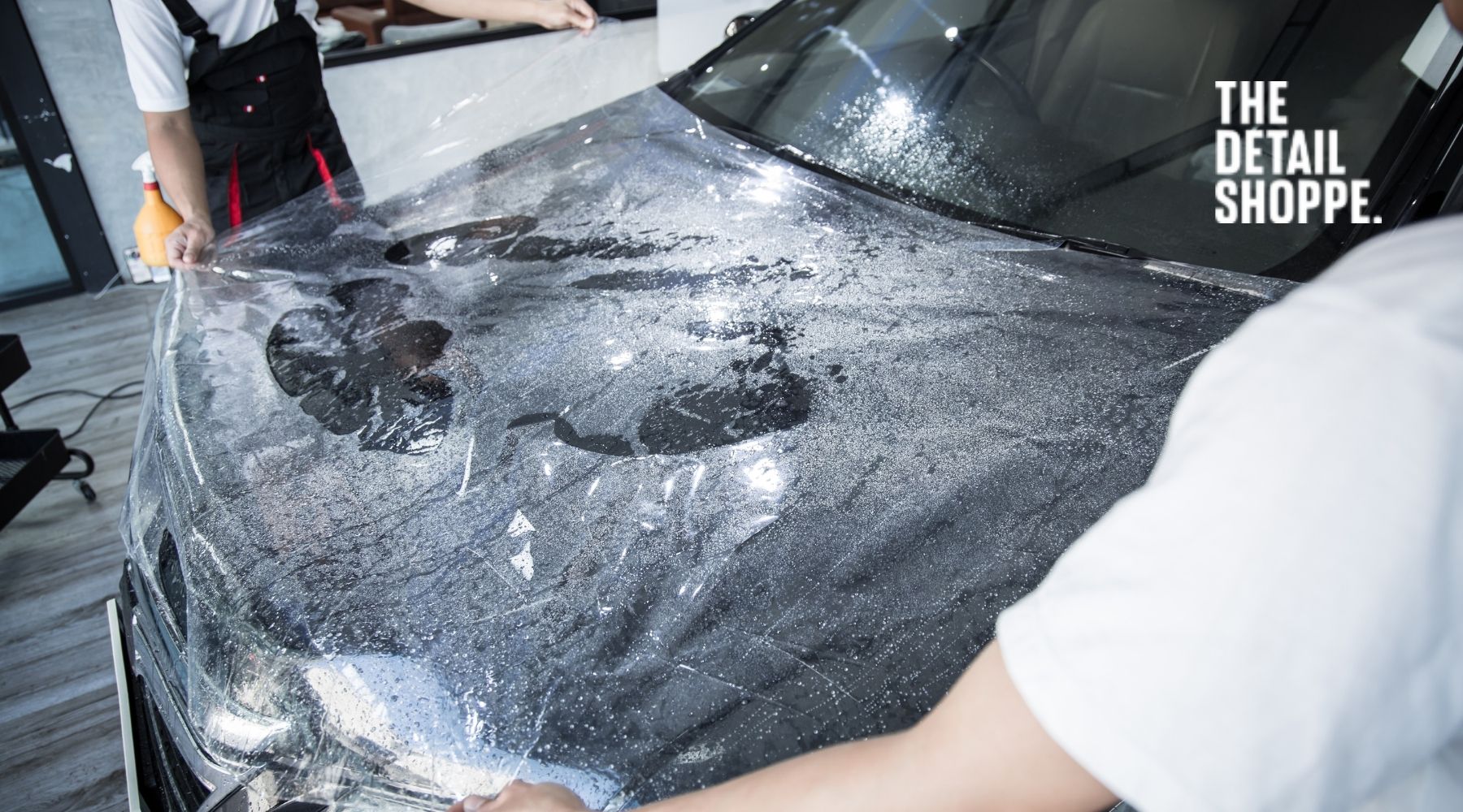 Professional paint protection film installation being applied to a car hood at The Detail Shoppe in Happy Valley, Oregon.