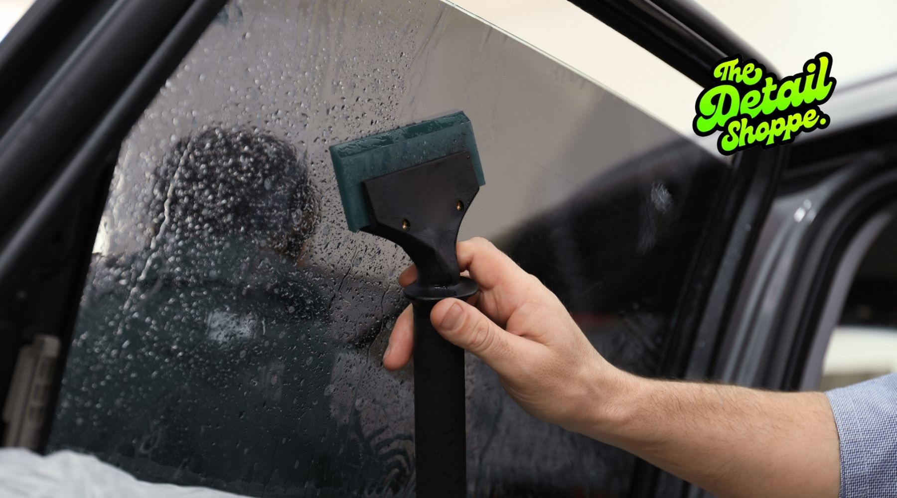Technician applying ceramic window tint film by hand on car window for smooth, bubble-free installation in Happy Valley